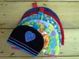 A selection of handmade teacozies n bright retro fabrics made at Tuftydawn Designs